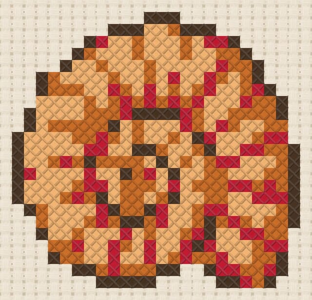 Ammonite finished in cross stitch on Aida cloth