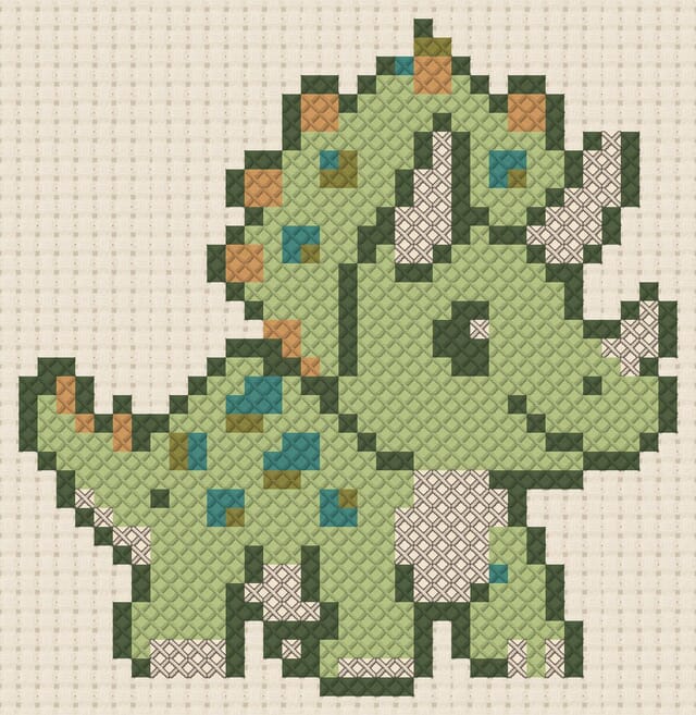 Baby triceratops finished in cross stitch on Aida cloth