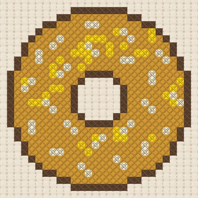 Bagel finished in cross stitch on Aida cloth