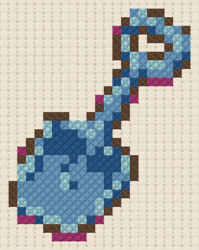 Beach spade finished in cross stitch on Aida cloth