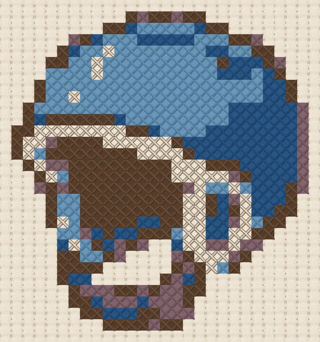 Bobble helmet finished in cross stitch on Aida cloth
