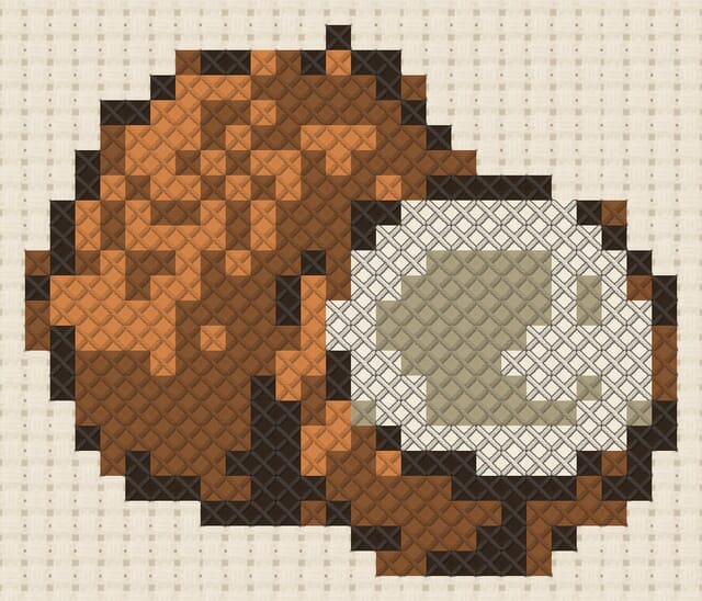 Coconut finished in cross stitch on Aida cloth