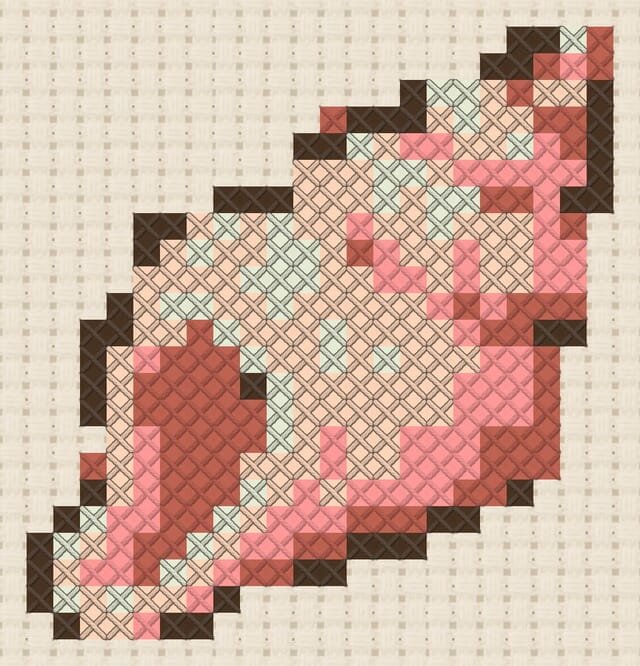 Conch shell finished in cross stitch on Aida cloth