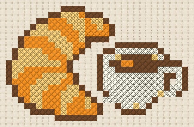 Croissant and coffee cup finished in cross stitch on Aida cloth