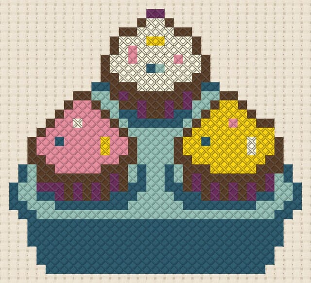 Cupcake tray finished in cross stitch on Aida cloth