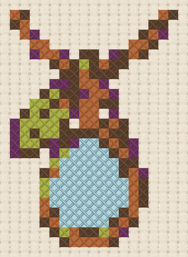 Dewdrop pendant finished in cross stitch on Aida cloth