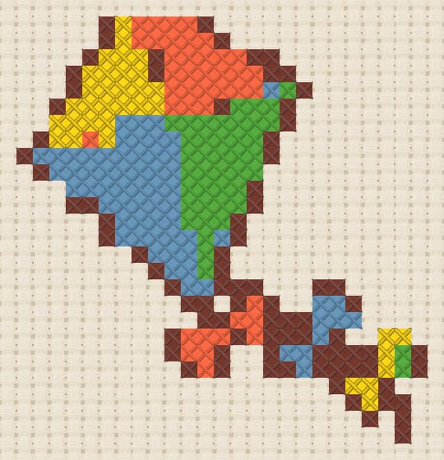 Diamond kite finished in cross stitch on Aida cloth