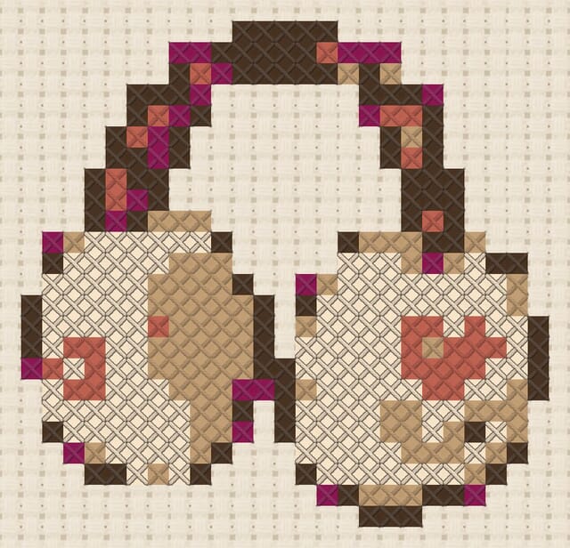 Earmuffs finished in cross stitch on Aida cloth