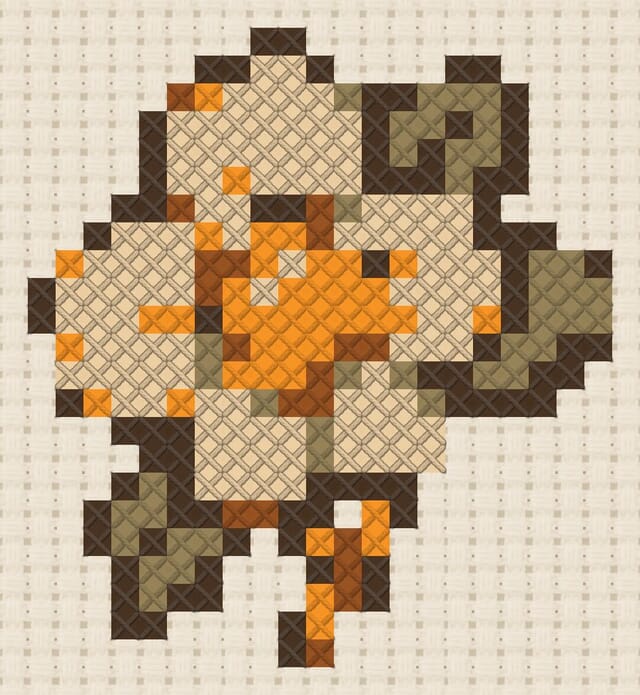 Flower brooch finished in cross stitch on Aida cloth