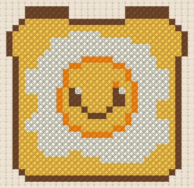 Fried egg and toast finished in cross stitch on Aida cloth