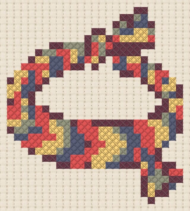 Friendship bracelet finished in cross stitch on Aida cloth