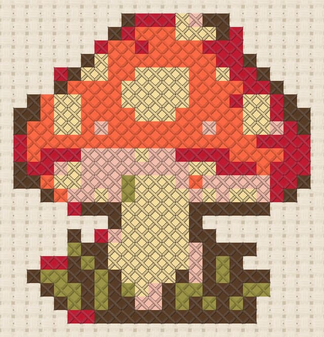 Glowing toadstool finished in cross stitch on Aida cloth