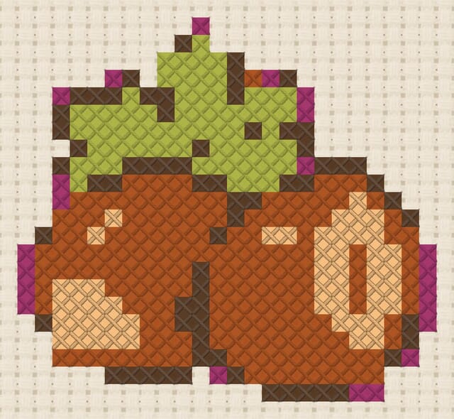 Hazelnuts finished in cross stitch on Aida cloth