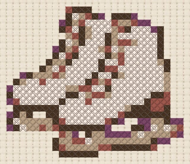 Ice skates finished in cross stitch on Aida cloth