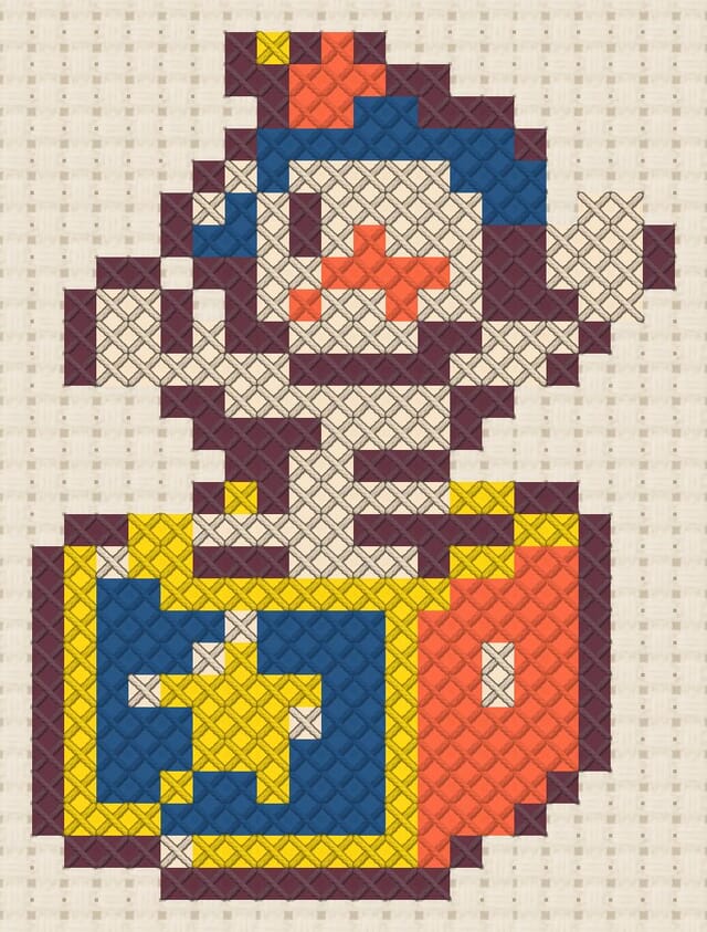 Jack-in-the-box finished in cross stitch on Aida cloth
