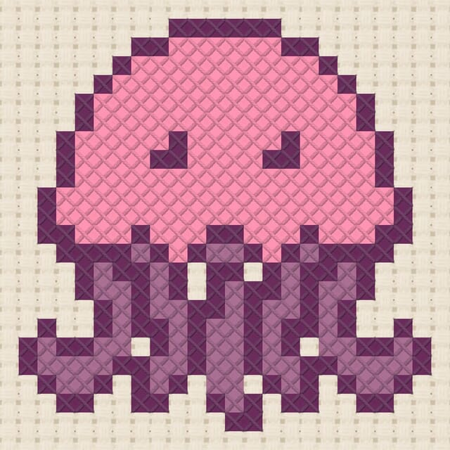 Jellyfish finished in cross stitch on Aida cloth