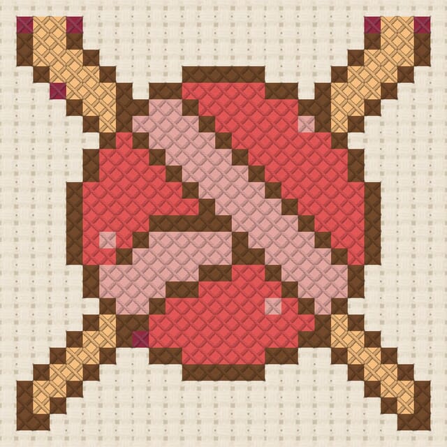 Knitting needles and yarn finished in cross stitch on Aida cloth