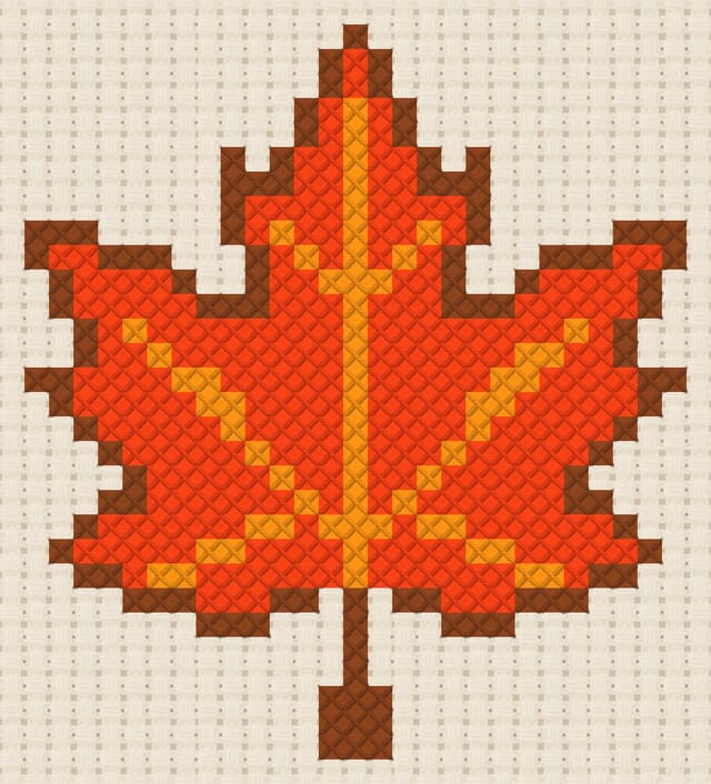 Maple leaf finished in cross stitch on Aida cloth
