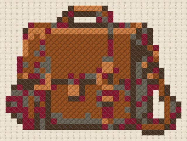 Leather satchel finished in cross stitch on Aida cloth