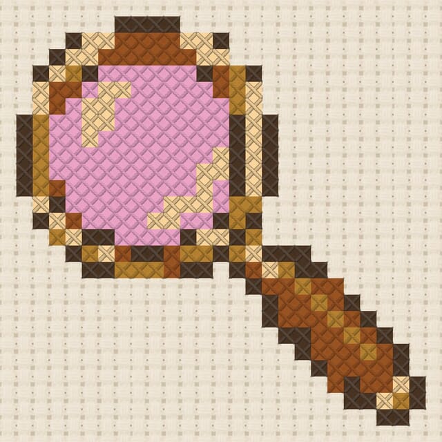 Magnifying glass finished in cross stitch on Aida cloth