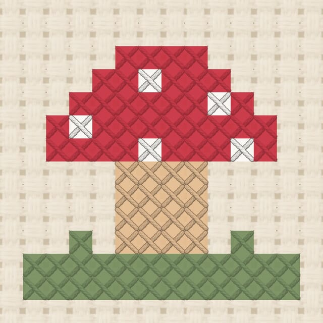Mushroom finished in cross stitch on Aida cloth