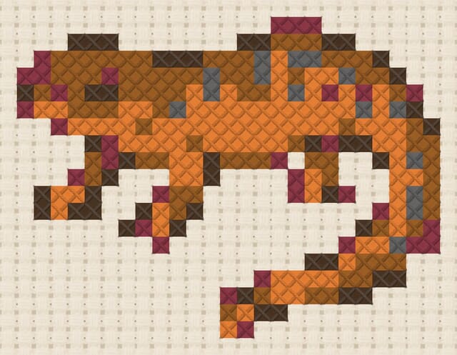 Newt finished in cross stitch on Aida cloth