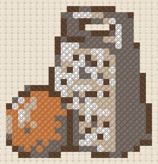 Nutmeg grater finished in cross stitch on Aida cloth