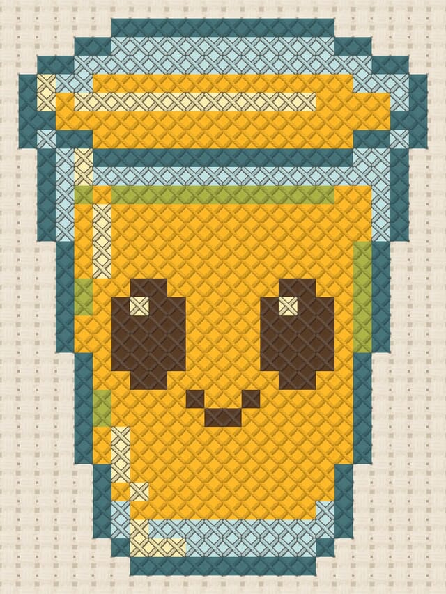 Orange juice glass finished in cross stitch on Aida cloth
