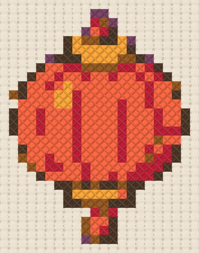Paper lantern finished in cross stitch on Aida cloth