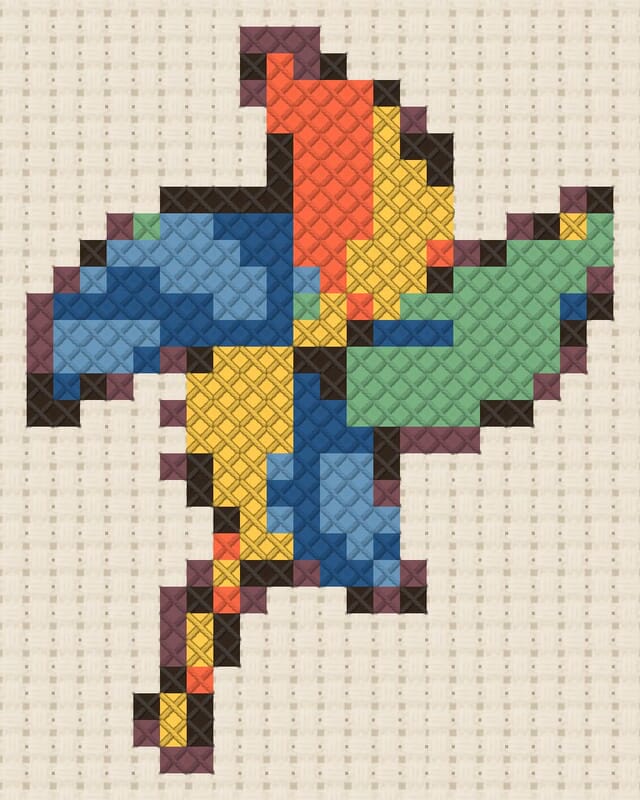 Paper pinwheel finished in cross stitch on Aida cloth