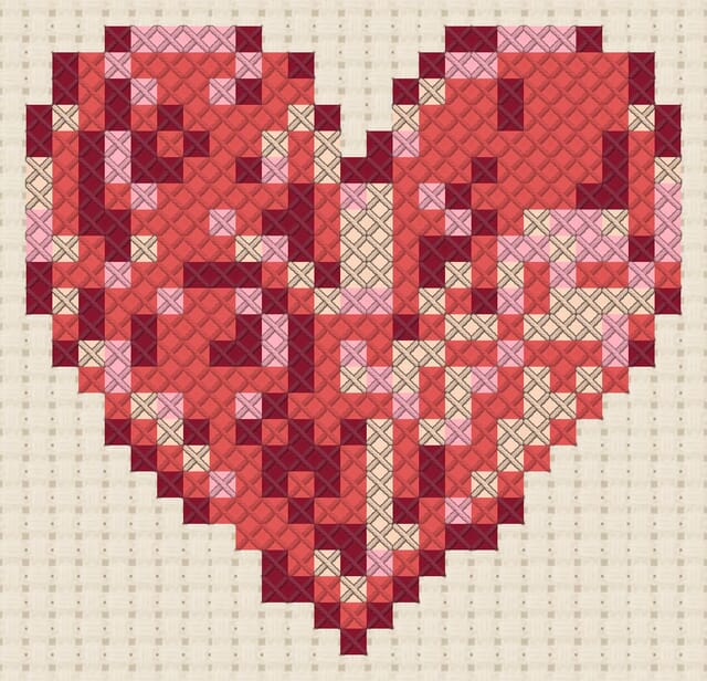 Paper quilling heart finished in cross stitch on Aida cloth