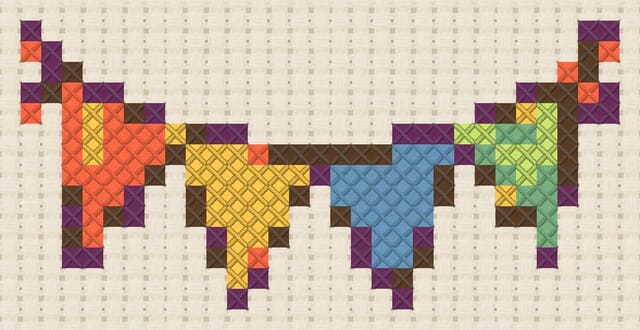 Party bunting finished in cross stitch on Aida cloth