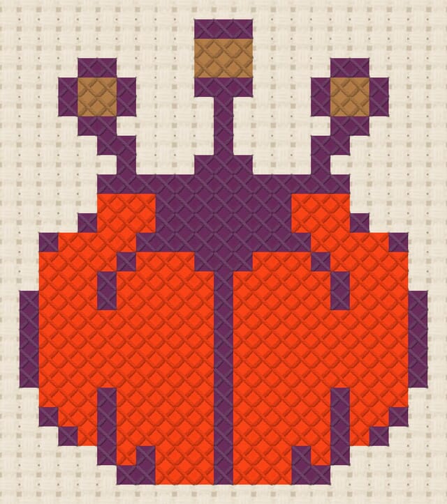 Pincushion finished in cross stitch on Aida cloth