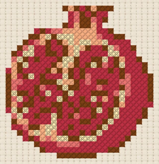 Pomegranate finished in cross stitch on Aida cloth