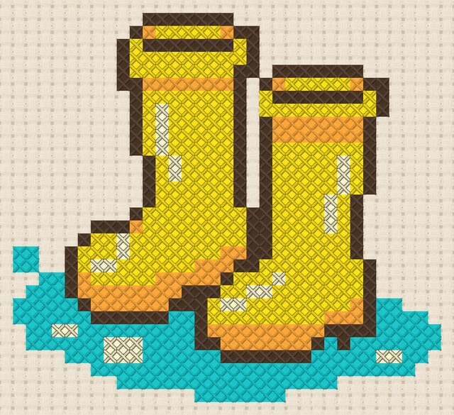 Rain boots and puddle finished in cross stitch on Aida cloth
