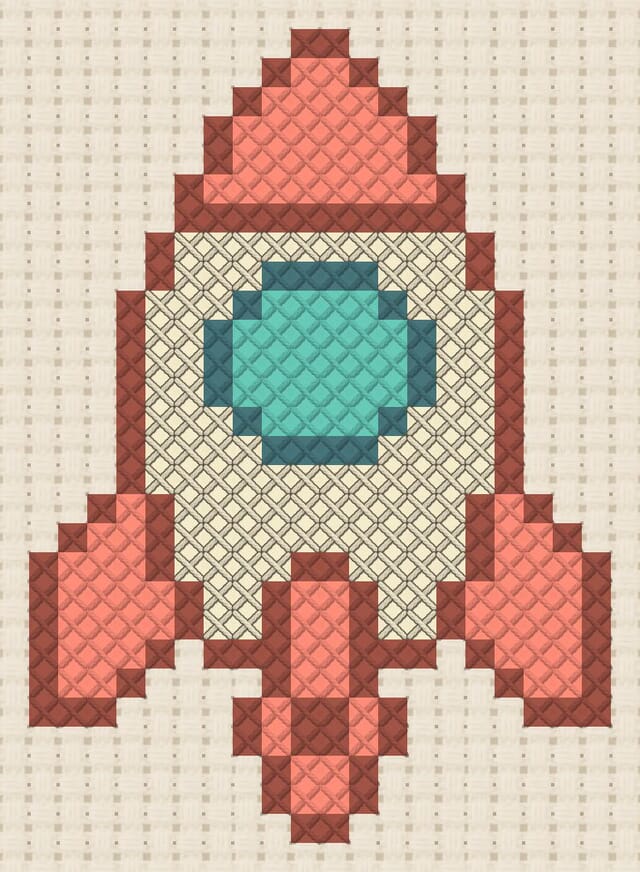 Rocket ship finished in cross stitch on Aida cloth
