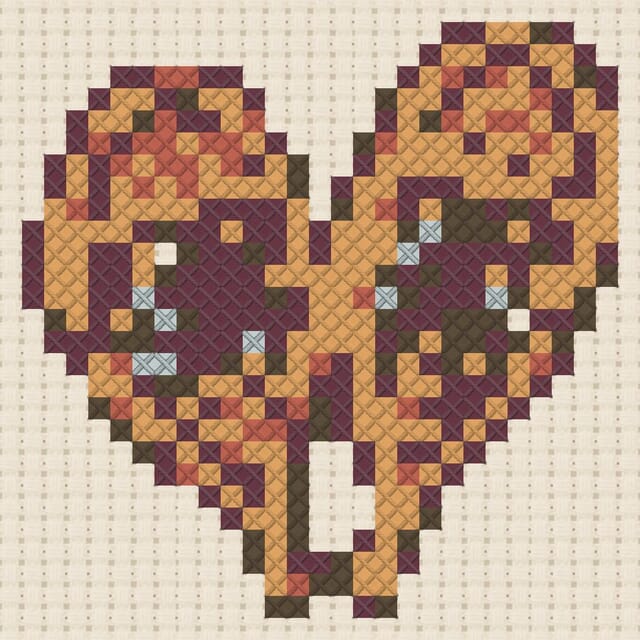 Snowshoes finished in cross stitch on Aida cloth