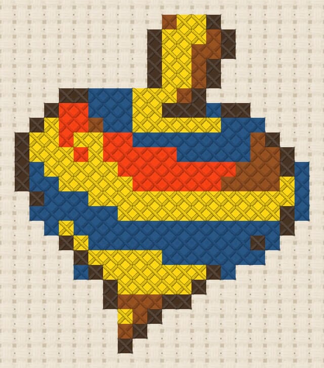 Spinning top finished in cross stitch on Aida cloth
