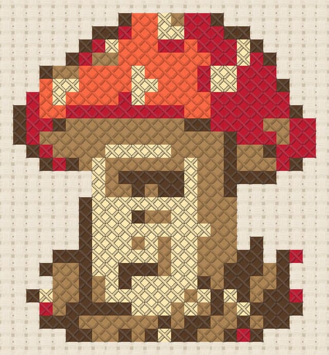 Toadstool postbox finished in cross stitch on Aida cloth