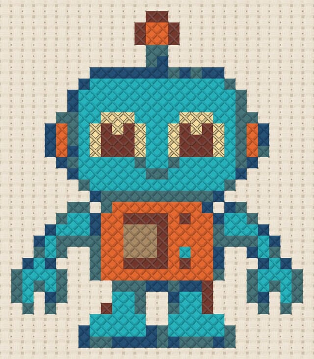 Toy robot finished in cross stitch on Aida cloth