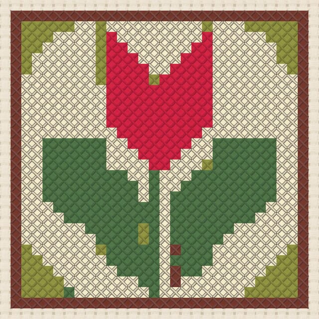 Tulip quilt block finished in cross stitch on Aida cloth